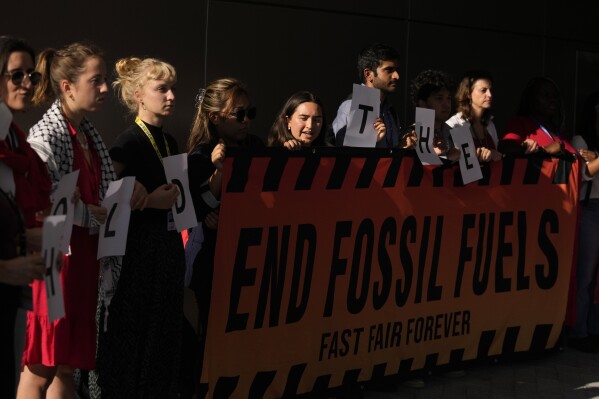 Activists participate in a demonstration for the end of fossil fuels at the COP28 U.N. Climate Summit, Sunday, Dec. 10, 2023, in Dubai, United Arab Emirates. (AP Photo/Rafiq Maqbool)