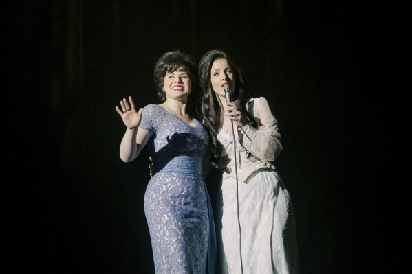 This image released by Lifetime shows Jessie Mueller as Loretta Lynn, right, and Megan Hilty as Patsy Cline in a scene from the TV film, "Patsy & Loretta." The film airs on Oct. 19 on Lifetime. (Jake Giles Netter/Lifetime via AP)