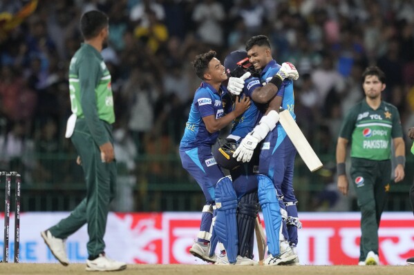 Sri Lanka's Charith Asalanka is embraced by Dunith Wellalage and Matheesha Pathirana as they celebrate their two wickets win in the Asia Cup cricket match between Pakistan and Sri Lanka in Colombo, Sri Lanka on Thursday, Sept.14, 2023. (AP Photo/Eranga Jayawardena)