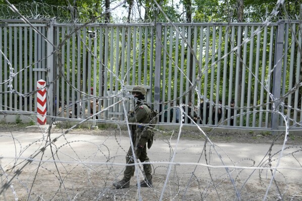FILE - A Polish soldier patrols the border with Belarus, in Bialowieza Forest, on May 29, 2024, the day after a young soldier, Mateusz Sitek, was stabbed in the chest by a migrant who thrust a knife through a gap in the fence. He died of his wounds on June 6. The Polish parliament observed a minute of silence to honor him on Wednesday, June 12, 2024. (AP Photo/Czarek Sokolowski, File)