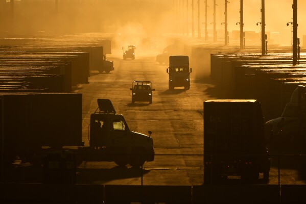 Workers drive among shipping containers and trailers at a BNSF intermodal terminal, Jan. 3, 2024, in Edgerton, Kan. On Wednesday, Feb. 28, 2024, the government issues the second of three estimates of GDP growth in the United States during the October-December quarter. (AP Photo/Charlie Riedel)