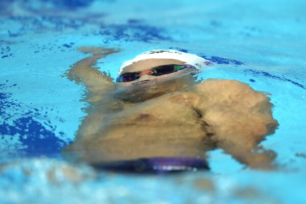 Thailand's Tonnam Kanteemool competes during the men's 100 meter backstroke swimming heat at the 19th Asian Games in Hangzhou, China, Sunday, Sept. 24, 2023. (AP Photo/Lee Jin-man)