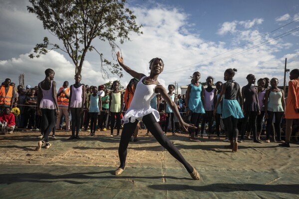Young dancers perform, during a Christmas ballet event in Kibera, one of the busiest neighborhoods of Kenya's capital, Nairobi, Friday, Dec. 15, 2023. The ballet project is run by Project Elimu, a community-driven nonprofit that offers after-school arts education and a safe space to children in Kibera. (AP Photo/Brian Inganga)