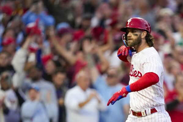 Philadelphia Phillies' Bryce Harper reacts after hitting a three run home run during the third inning of Game 3 of a baseball NL Division Series against the Atlanta Braves Wednesday, Oct. 11, 2023, in Philadelphia. (AP Photo/Matt Slocum)