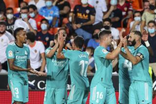 Real Madrid's Vinicius Junior celebrates with teammates after scoring his side's first goal during a Spanish La Liga soccer match between Valencia and Real Madrid at the Mestalla stadium in Valencia, Spain, Sunday, Sept. 19, 2021. (AP Photo/Alberto Saiz)