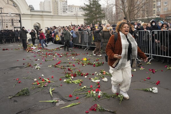 People break barriers after a van with the coffin of Russian opposition leader Alexei Navalny left the Church of the Icon of the Mother of God Soothe My Sorrows, in Moscow, Russia, Friday, March 1, 2024. Alexei Navalny, Russia's top opposition leader and President Vladimir Putin's fiercest foe, has been buried in Moscow, two weeks after his still-mysterious death in an Arctic prison. (AP Photo)