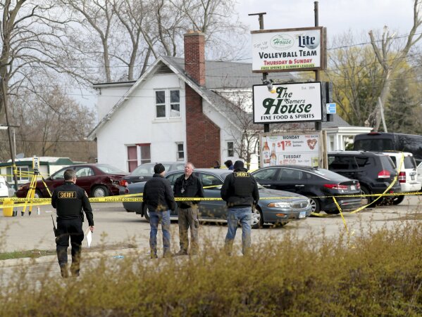Officials investigate the scene of a deadly shooting at Somers House Tavern in Kenosha, Wis., Sunday, April 18, 2021. Several people were killed and two were seriously wounded in a shooting at the busy tavern in southeastern Wisconsin early Sunday, sheriff's officials said. (Mike De Sisti/Milwaukee Journal-Sentinel via AP)