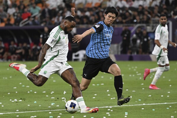 Al Ahli's Ivan Toney, left, attempts a shot at goal in front of Kawasaki Flontale's Kota Takai during to the AFC Champions League Elite final soccer match between Kawasaki Flontale and Al Ahli at Alinma Stadium in Jeddah, Saudi Arabia, Saturday, May 3, 2025. (AP Photo/Ali Issa)