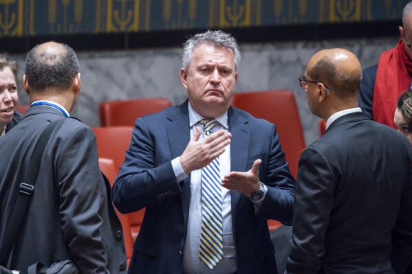 Ukrainian Ambassador to the United Nations Sergiy Kyslytsya, center, speaks with James Kariuki, Deputy Permanent Representative of the United Kingdom to the United Nations, left and Robert Wood Deputy permanent representative of the United States to the United Nations at the end of a security council meeting in the United Nations Headquarters, Monday, Jan. 22, 2024. (AP Photo/Eduardo Munoz Alvarez)