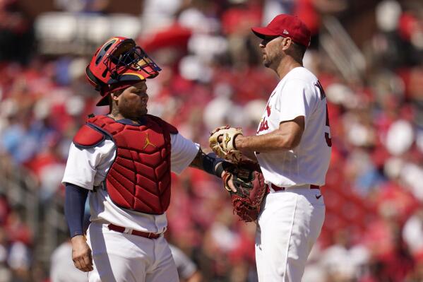 St. Louis Cardinals catcher Yadier Molina, left, talks to starting pitcher Adam Wainwright during the fifth inning of a baseball game against the Washington Nationals Thursday, Sept. 8, 2022, in St. Louis. (AP Photo/Jeff Roberson)
