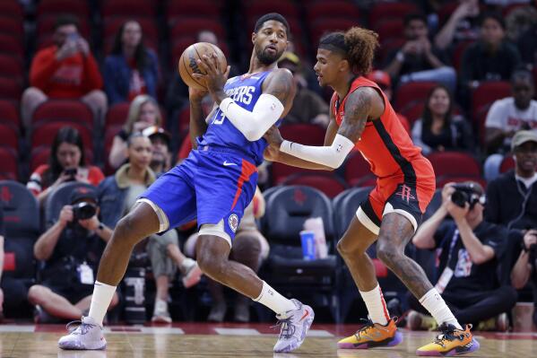 Los Angeles Clippers guard Paul George (13) leans back into Houston Rockets guard Jalen Green during the first half of an NBA basketball game Wednesday, Nov. 2, 2022, in Houston. (AP Photo/Michael Wyke)