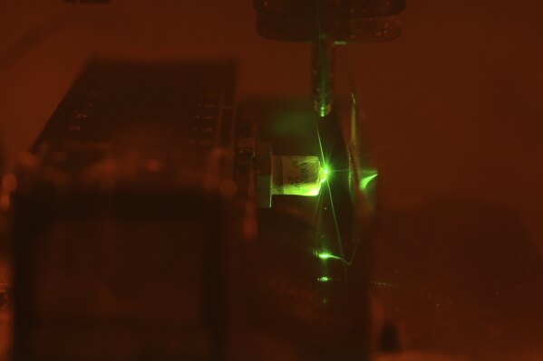 A diamond is cut by laser at Shree Ramkrishna Exports in Surat, India, on April 14, 2025. (AP Photo/Ajit Solanki)