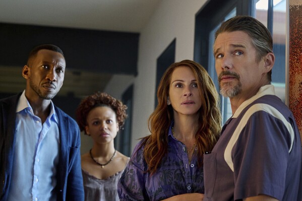 This image released by Netflix shows Mahershela Ali from left, Myha'la Herrold, Julia Roberts and Ethan Hawke in a scene from "Leave the World Behind." (JoJo Whilden/Netflix via AP)