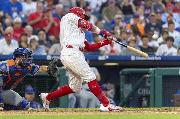 Philadelphia Phillies' Kyle Schwarber hits a solo home run during the fourth inning of a baseball game against the New York Mets, Sunday, June 22, 2025, in Philadelphia. (AP Photo/Laurence Kesterson)