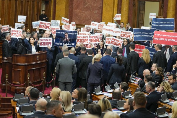 Opposition lawmakers hold banners reading: "Stole the elections" during a Serbia's parliament constitutive session in Belgrade, Serbia, Tuesday, Feb. 6, 2024. Serbia's National Assembly held an inaugural session on Tuesday as ruling nationalists ignored widespread reports that parliamentary and municipal elections held in December were marred by vote rigging and other irregularities. (AP Photo/Darko Vojinovic)