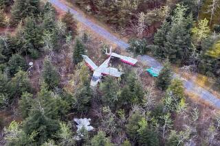 In this photo provided by the U.S. Coast Guard is the scene where a Dehavilland DHC-3 fixed-wing single engine plane crashed near Yakutat, Alaska, on Tuesday, May 24, 2022. All four people on board an airplane were injured when it crashed Tuesday while attempting to land at a rural Alaska air strip. Three of those hurt were eventually sent to hospitals in Anchorage while the fourth with minor injuries was treated in Yakutat. (U.S. Coast Guard via AP)