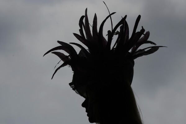 A race fan walks through the stands at Churchill Downs before the 151st running of the Kentucky Oaks horse race Friday, May 2, 2025, in Louisville, Ky. (AP Photo/Charlie Riedel)