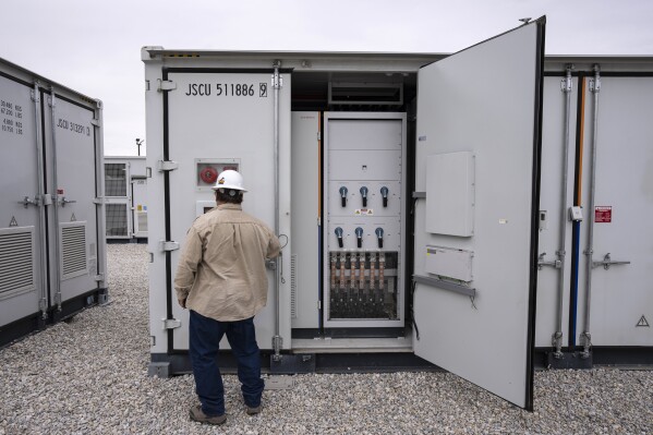 FILE - An employee works at a battery energy storage facility in Saginaw, Texas, April 25, 2023, that is owned and operated by Eolian L.P. The U.S. Department of Energy on Friday, Sept. 22, announced a $325 million investment in long-duration battery storage projects. (AP Photo/Sam Hodde, File)