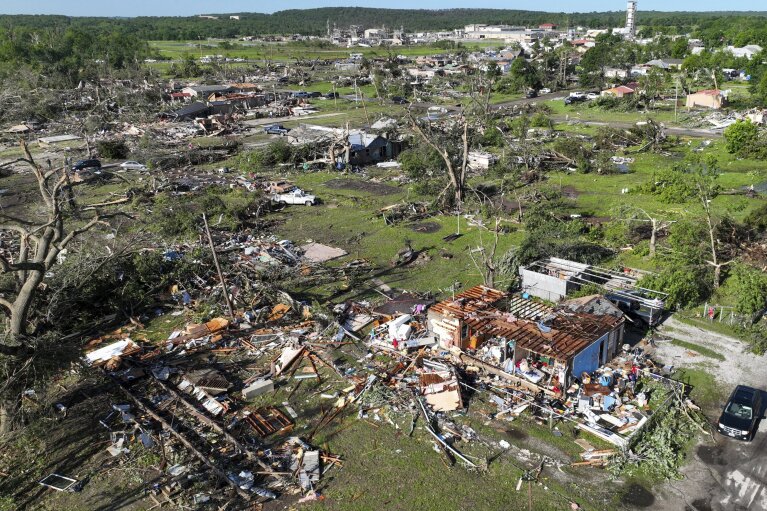 Debris and damage from powerful storms are seen, Tuesday, May 7, 2024 in Barnsdall, Okla. A tornado destroyed homes, forced the evacuation of a nursing home and toppled trees and power lines when it roared through the small Oklahoma town. (Mike Simons/Tulsa World via AP)