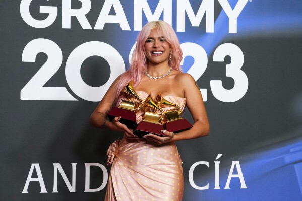 Karol G poses with the awards for best urban album for "Mañana Sera Bonito", for album of the year for "Mañana Sera Bonito" and the award for best urban fusion/performance for "TQG" during the 24th annual Latin Grammy Awards in Seville, Spain, Thursday, Nov. 16, 2023. (Photo by Jose Breton/Invision/AP)