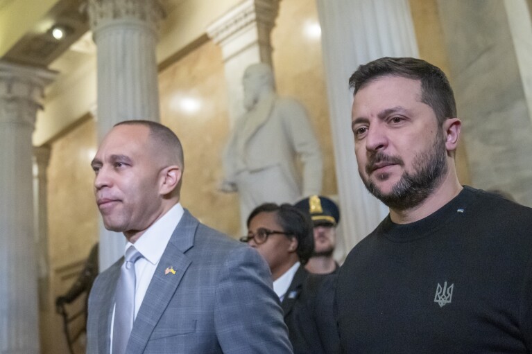 FILE - House Minority Leader Hakeem Jeffries of N.Y., left, walks with Ukrainian President Volodymyr Zelenskyy in the U.S. Capitol to a meeting with other congressional leaders, Dec. 12, 2023, in Washington. (AP Photo/Alex Brandon, File)