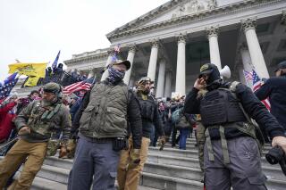 FILE - Members of the Oath Keepers extremist group stand on the East Front of the U.S. Capitol on Jan. 6, 2021, in Washington. The Capitol riot was the culmination of weeks of preparation and a moment of triumph for the Oath Keepers, federal prosecutor Louis Manzo said Jan. 18, 2023, in closing arguments in the second seditious conspiracy trial against members of the far-right extremist group. The defendants facing jurors in the latest trial are Joseph Hackett, Roberto Minuta, David Moerschel, and Edward Vallejo. (AP Photo/Manuel Balce Ceneta, File)