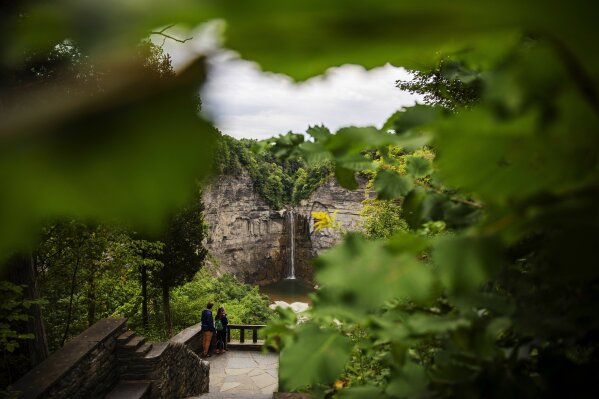 A couple looks out over Taughannock Falls where Krista Johnston and her late husband, Sgt. James Johnston, used to meet for lunch in Trumansburg, N.Y., Sunday, Sept. 1, 2019. The two were high school sweethearts. She liked his easy smile, his jokes, his courtly Southern manner; he first called her Miss Krista and opened doors for her. Soon, they were inseparable, two outdoorsy types, zipping around the woods, splashing in the mud in a four-wheeler, hunting deer. (AP Photo/David Goldman)