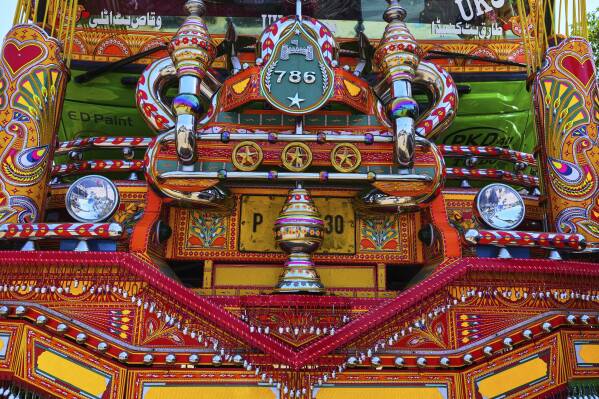 Decorated metal pieces are mounted on the front of a newly refurbished truck at a yard for workshops in Rawalpindi, Pakistan, Thursday, April 24, 2025. (AP Photo/Anjum Naveed)