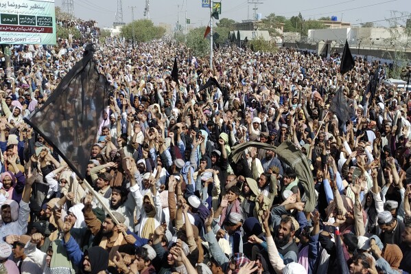 Local residents and Afghan nationals chant slogan during a protest rally in the southwestern border town of Chaman, Pakistan, Thursday, Oct. 26, 2023. Tens of thousands of people, including Afghans, rallied in Chaman to denounce the government plan under which they are now required to travel to Afghanistan on visa. Earlier, special permits had been given to the residents to visit Afghanistan. The rallygoers also opposed the crackdown against the Afghans, demanding it should be reversed. (AP Photo/Jafar Khan)