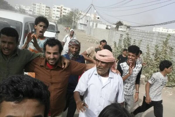 
              In this Monday, June 25, 2018 photo, Yemeni actor Nasser al-Anbari, in brown shirt, is greeted by his family and friends after his release from a prison controlled by the United Arab Emirates where he and others had been held without charges for nearly a year, in Aden, Yemen. The release on Monday came days after The Associated Press revealed that hundreds of Yemeni prisoners swept up in anti-terror raids by Emirati-backed forces have been subjected to torture and sexual abuse. The UAE has denied it controls any prisons in Yemen. (AP Photo)
            