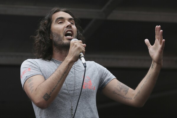Comedian Russell Brand speaks in Parliament Square during a protest against the Conservative Government and it's austerity policies in London, Saturday, June 20, 2015. (AP Photo/Tim Ireland, File)
