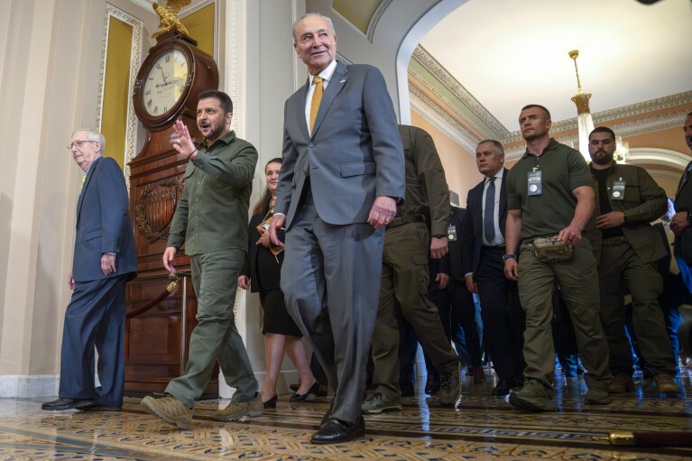 Ukrainian President Volodymyr Zelenskyy, second from left, walks with Senate Minority Leader Mitch McConnell of Ky., left, and Senate Majority Leader Chuck Schumer of N.Y., right, at Capitol Hill on Thursday, Sept. 21, 2023, in Washington. (AP Photo/Mark Schiefelbein)