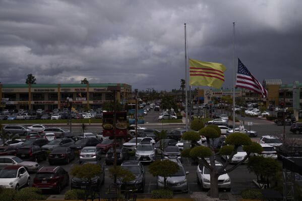 Large U.S. and former South Vietnamese flags fly in the wind in the parking lot of Asian Garden Mall in the Little Saigon neighborhood of Westminster, Calif., Saturday, April 26, 2025. (AP Photo/Jae C. Hong)