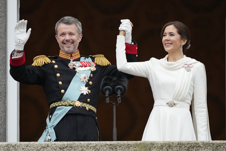 Denmark's King Frederik X and Denmark's Queen Mary wave from the balcony of Christiansborg Palace in Copenhagen, Denmark, Sunday, Jan. 14, 2024. Queen Margrethe II has become Denmark's first monarch to abdicate in nearly 900 years when she handed over the throne to her son, who has become King Frederik X. (AP Photo/Martin Meissner)