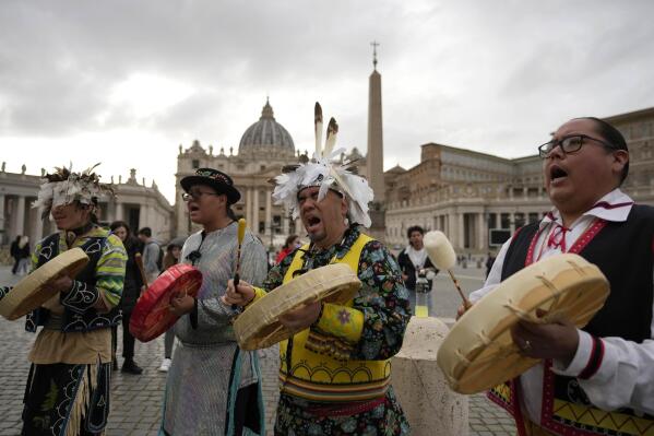Members of the Assembly of First Nations perform in St. Peter's Square at the Vatican, Thursday, March 31, 2022. Pope Francis has welcomed First Nations delegations to the Vatican. They are seeking an apology for the Catholic Church's role in running Canada's notorious residential schools for Indigenous children. (AP Photo/Alessandra Tarantino)