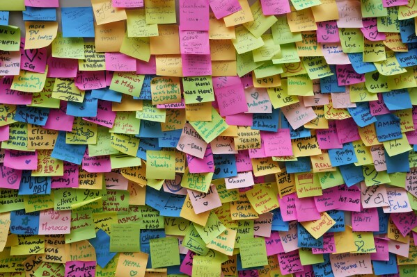 Messages are stuck to a wall outside the Indonesia Pavilion at the COP28 U.N. Climate Summit, Dec. 10, 2023, in Dubai, United Arab Emirates. (AP Photo/Rafiq Maqbool)