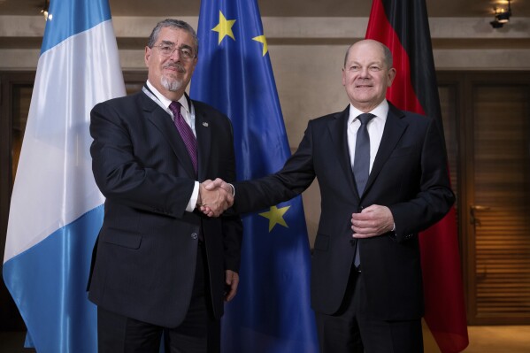 Cesar Bernardo Arevalo de Leon, left, President of Guatemala, and German Chancellor Olaf Scholz, right, shake hands during a meeting as part of the Munich Security Conference in Munich, Germany, Saturday, Feb. 17, 2024. The 60th Munich Security Conference (MSC) is taking place from Feb. 16 to Feb. 18, 2024. (Sven Hoppe/DPA via AP, Pool)