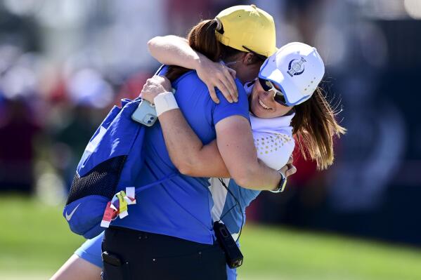 Europe's Leona Maguire celebrates with her sister Lisa after defeating United States' Jennifer Kupcho on the 15th hole during the singles matches at the Solheim Cup golf tournament, Monday, Sept. 6, 2021, in Toledo, Ohio. (AP Photo/David Dermer)