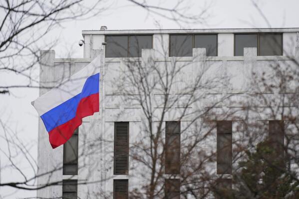 FILE - The Russian flag flies outside the Embassy of Russia in Washington, Feb. 24, 2022. The United States and allies are stepping up sanctions against Russia over its invasion of Ukraine.  (AP Photo/Patrick Semansky, File)