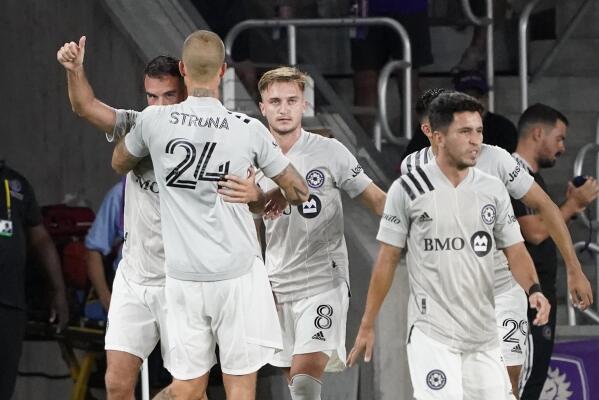 CF Montreal's Rudy Camacho, far left, celebrates his goal against Orlando City with teammates including KiKi Struna (24) and Djordje Mihailovic (8) during the second half of an MLS soccer match, Wednesday, Oct. 20, 2021, in Orlando, Fla. (AP Photo/John Raoux)