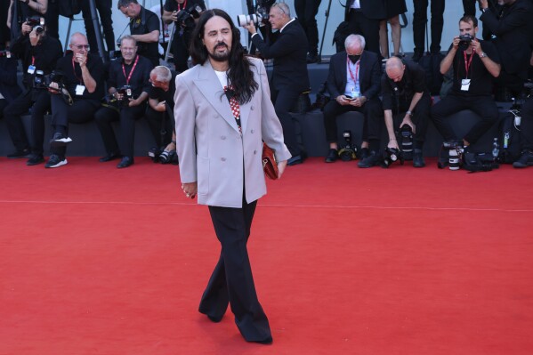 FILE - Alessandro Michele poses for photographers upon arrival at the premiere of the film 'Don't Worry Darling' during the 79th edition of the Venice Film Festival in Venice, Italy, on Sept. 5, 2022. The flamboyant former designer of Gucci Alessandro Michele has been named the new creative director at storied Roman luxury house Valentino, following the sudden departure last week of Pierpaolo Piccioli after 25 years. Valentino confirmed the move in a statement Thursday March 28, 2024. (Photo by Joel C Ryan/Invision/AP, File)