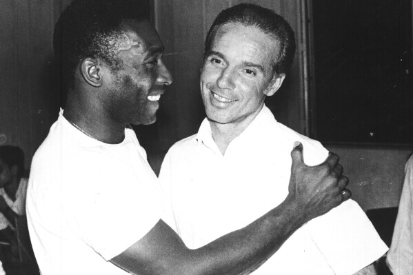 FILE - Brazil's soccer star Pele, left, embraces Mario Zagallo after the latter's appointment as coach of the Brazilian national soccer team, in Rio De Janeiro, Brazil, in March 1970. Zagallo, who reached the World Cup final a record five times, winning four, as a player and then a coach with Brazil, has died. He was 92. Brazilian soccer confederation president Ednaldo Rodrigues said in a statement in the early hours of Saturday, Jan. 5, 2024, confirming Zagallo's death that Zagallo 