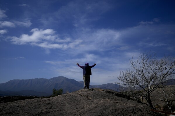 Jorge Hector Roldan, better known as Larry, stands with his arms spread out, facing the Uritorco mountains in Capilla del Monte, Cordoba, Argentina, Tuesday, July 18, 2023. In the pope’s homeland of Argentina, Catholics have been renouncing the faith and joining the growing ranks of the religiously unaffiliated. Commonly known as the “nones,” they describe themselves as atheists, agnostics, spiritual but not religious, or simply: “nothing in particular.” (AP Photo/Natacha Pisarenko)