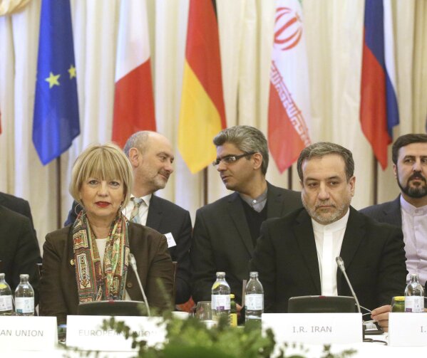 The European Union's political director Helga Schmid and Iran's deputy Foreign Minister Abbas Araghchi, from left, wait for a bilateral meeting as part of the closed-door nuclear talks with Iran in Vienna, Austria, Wednesday, Feb. 26, 2020. (AP Photo/Roland Zak)