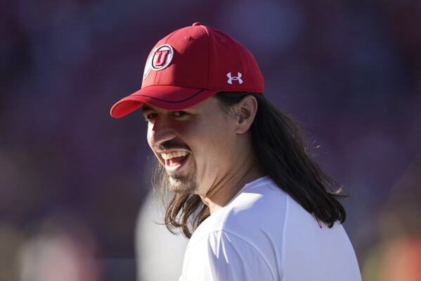 Utah quarterback Cameron Rising warms up before an NCAA college football game against Southern California, Saturday, Oct. 21, 2023, in Los Angeles. (AP Photo/Ryan Sun)