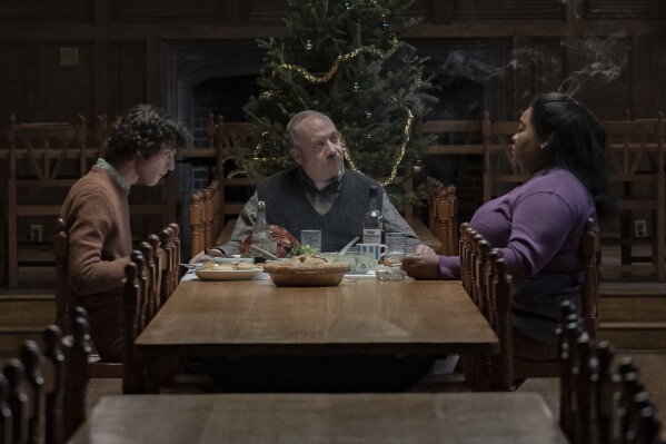 This image released by Focus Features shows Dominic Sessa, from left, Paul Giamatti and Da'Vine Joy Randolph in a scene from "The Holdovers." (Seacia Pavao/Focus Features via AP)
