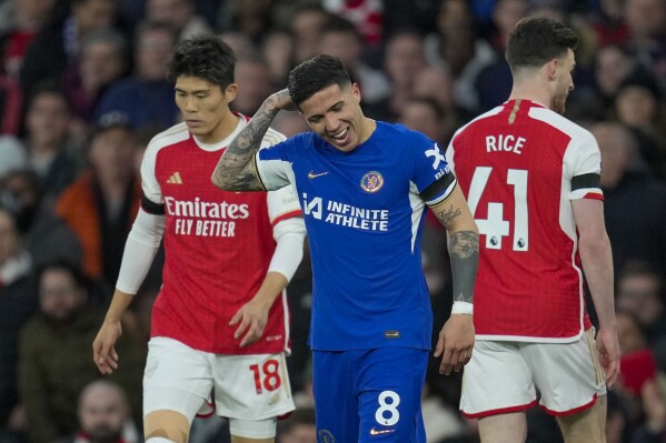 Chelsea's Enzo Fernandez, center, reacts after Arsenal's Leandro Trossard scoring his side's opening goal during the English Premier League soccer match between Arsenal and Chelsea at Emirates Stadium in London, Tuesday, April 23, 2024. (AP Photo/Kin Cheung)