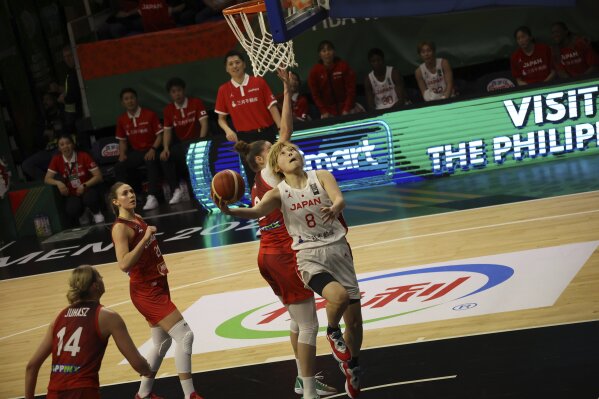 Maki Takada of Japan goes to the basket during the women's basketball Olympic qualifying tournament second round match between Japan and Hungary in Sopron, Hungary, Friday, Feb. 9, 2024. (Zsombor Toth/MTI via AP)
