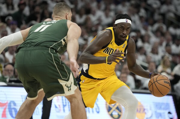 Indiana Pacers' Pascal Siakam tries to get past Milwaukee Bucks' Brook Lopez during the second half of Game 2 of the first round NBA playoff basketball series Tuesday, April 23, 2024, in Milwaukee.The Pacers won 125-108 to tie the series 1-1. (AP Photo/Morry Gash)