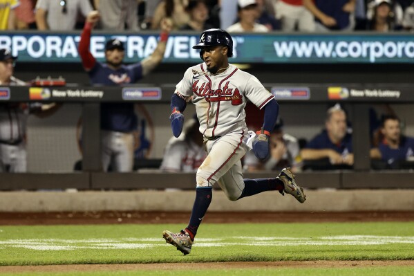 Atlanta Braves' Ozzie Albies runs home to score during the eighth inning in the second baseball game of a doubleheader on Saturday, Aug. 12, 2023, in New York. (AP Photo/Adam Hunger)